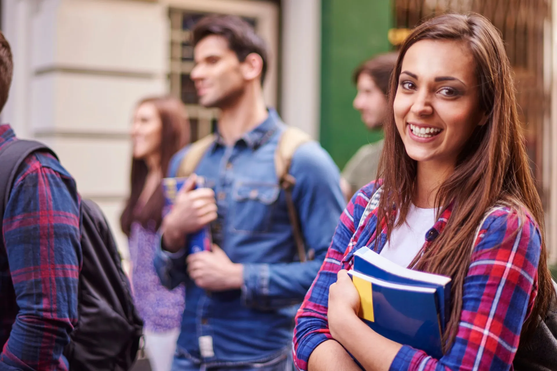 female-student-holding-her-books-scaled.jpg