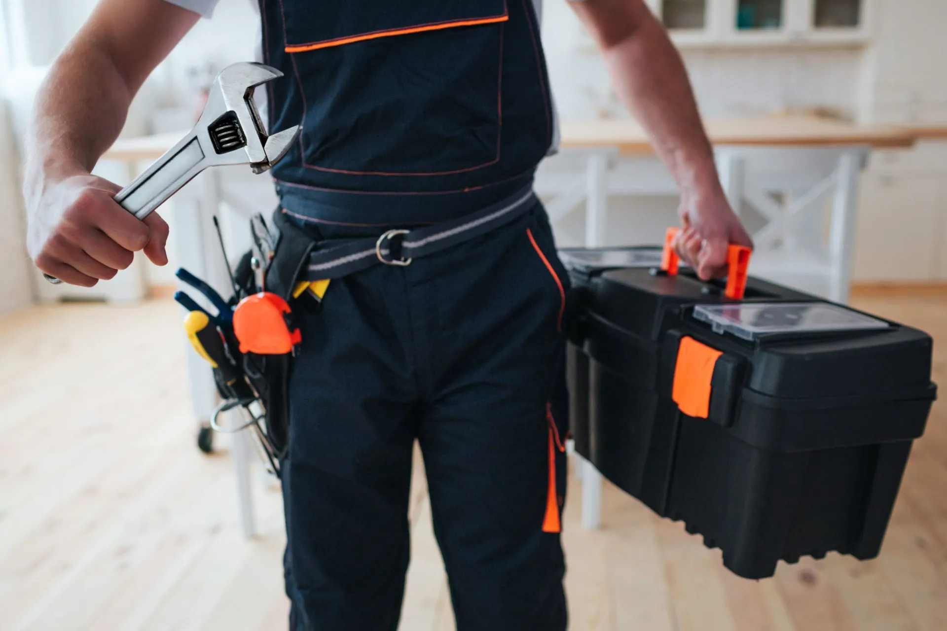 handyman-holding-toolbox-wrench-hands-scaled.jpg