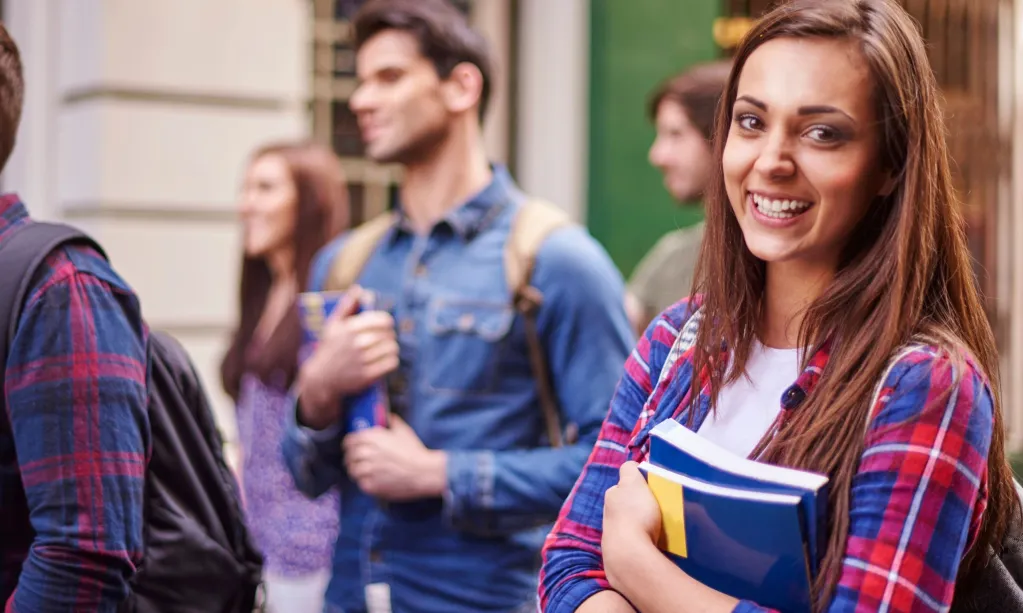 female-student-holding-her-books-scaled.jpg