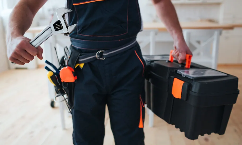 handyman-holding-toolbox-wrench-hands-scaled.jpg